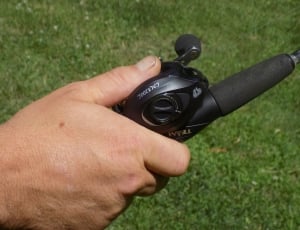person holding black fishing rod thumbnail