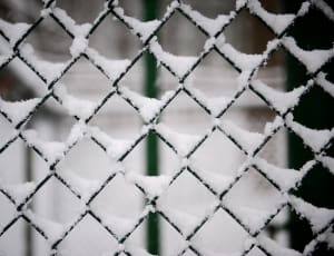 gray cyclone fence with snow thumbnail