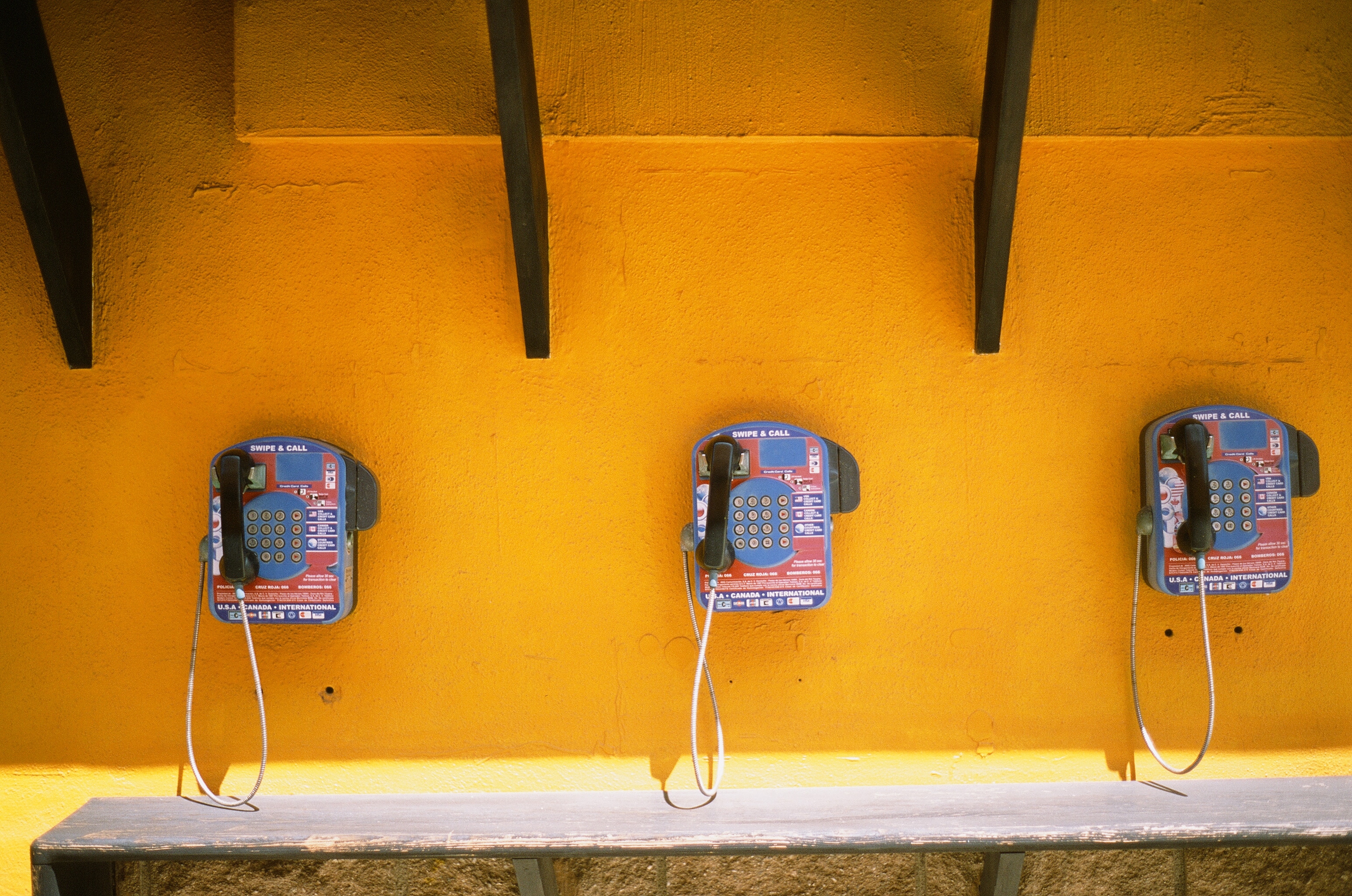 3 blue and black payphones