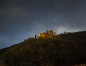 brown castle under cloudy sky thumbnail