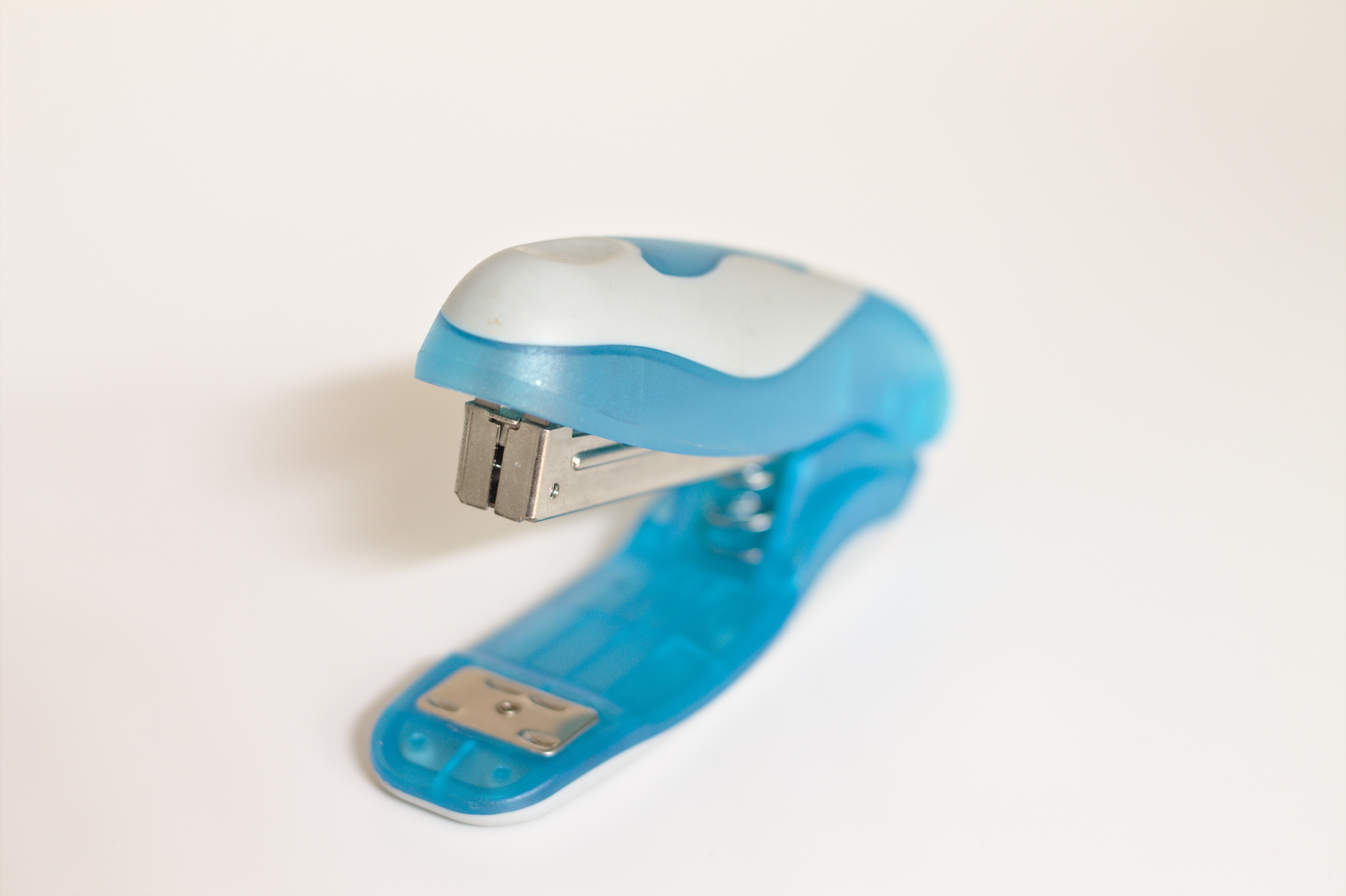 white and blue stapler