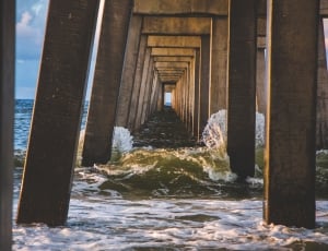 view under wooden bridge on a body of water thumbnail