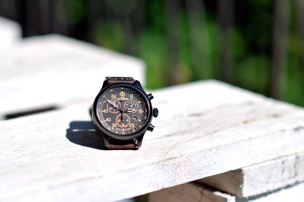 brown strap chronograph watch on wooden table preview