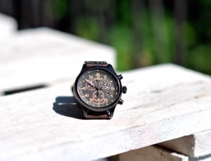 brown strap chronograph watch on wooden table thumbnail