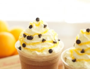 brown beverage with white cream and chocolate sprinkles on top thumbnail