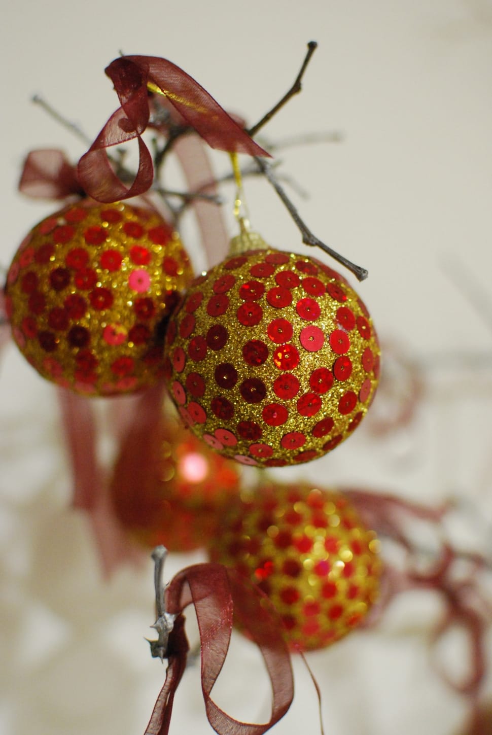red and yellow sequined christmas baubles preview