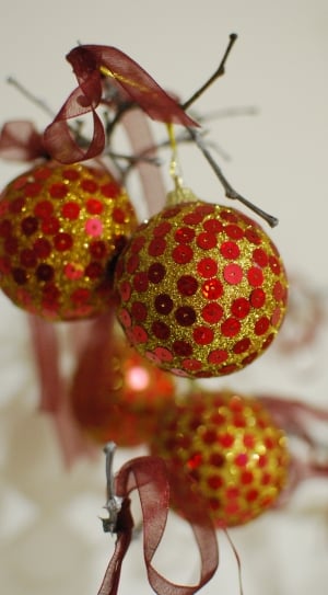 red and yellow sequined christmas baubles thumbnail