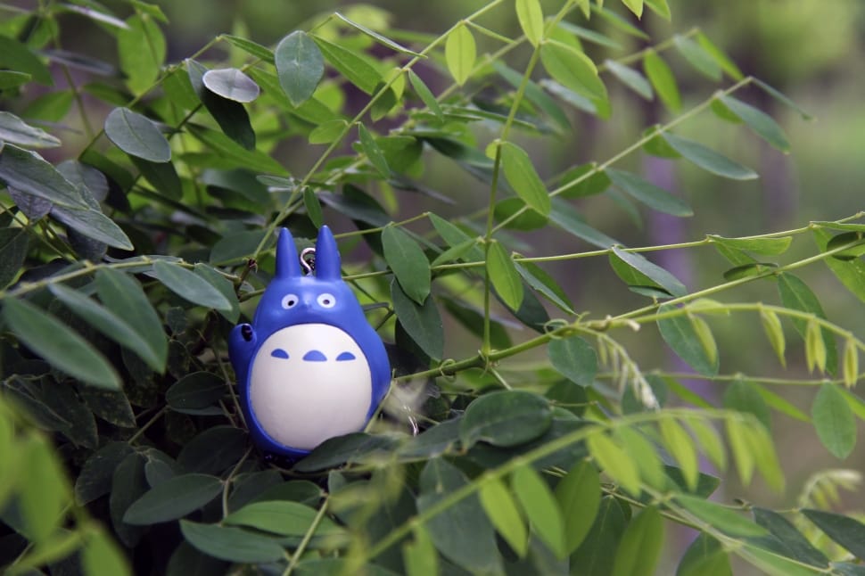white and blue plastic toy in green leaf tree preview