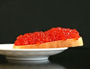 loaf of bread with fruit jam served on a white platter thumbnail