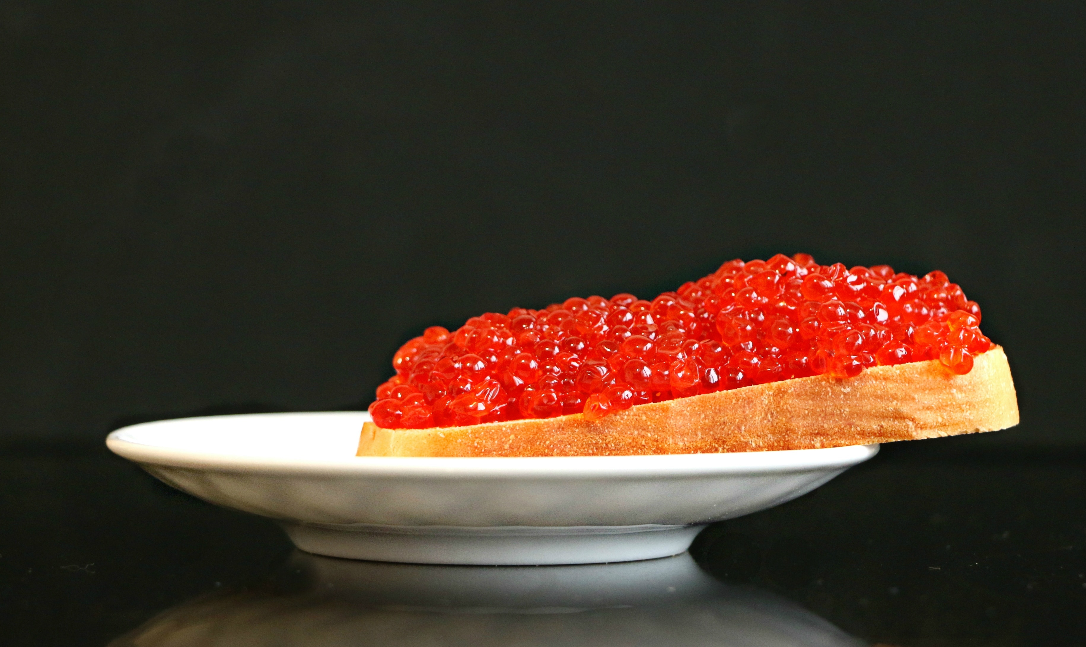 loaf of bread with fruit jam served on a white platter