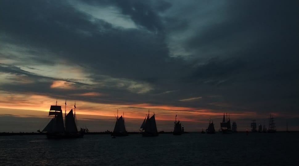 silhouette photo of Ships during sunset preview