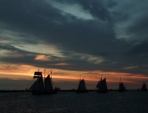 silhouette photo of Ships during sunset thumbnail