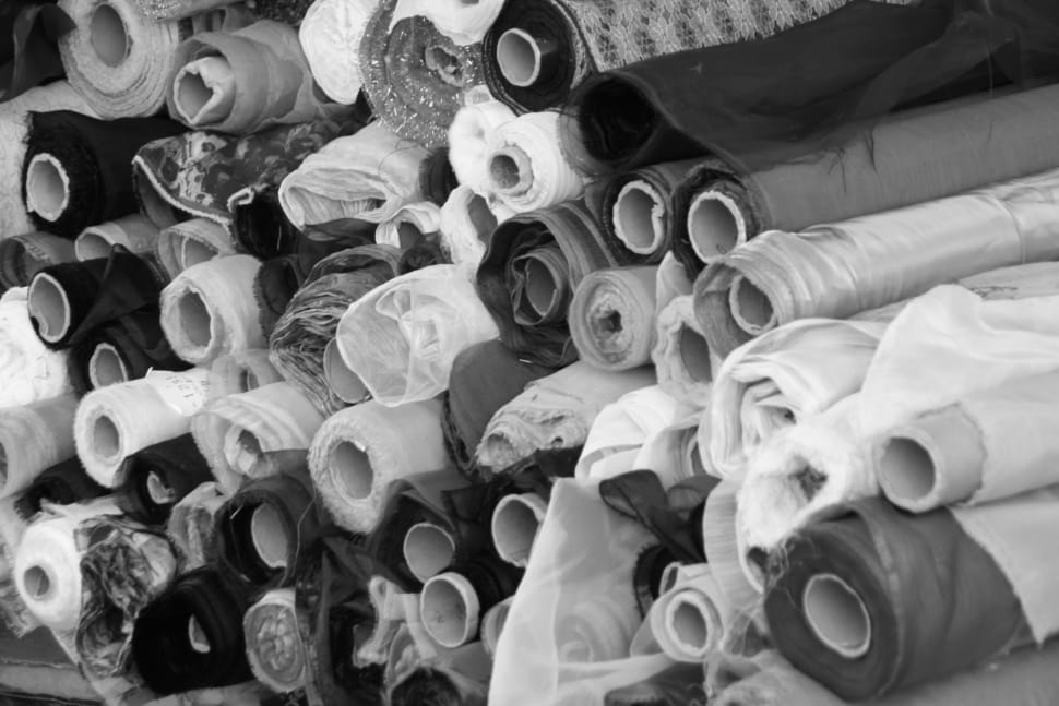 grayscale photo of rolled textile lot preview