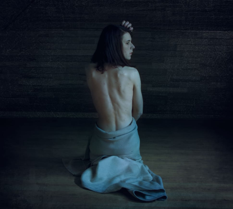 naked woman sitting with white textile wrap on the lower body part sitting on brown wooden tiled floor free image - Peakpx