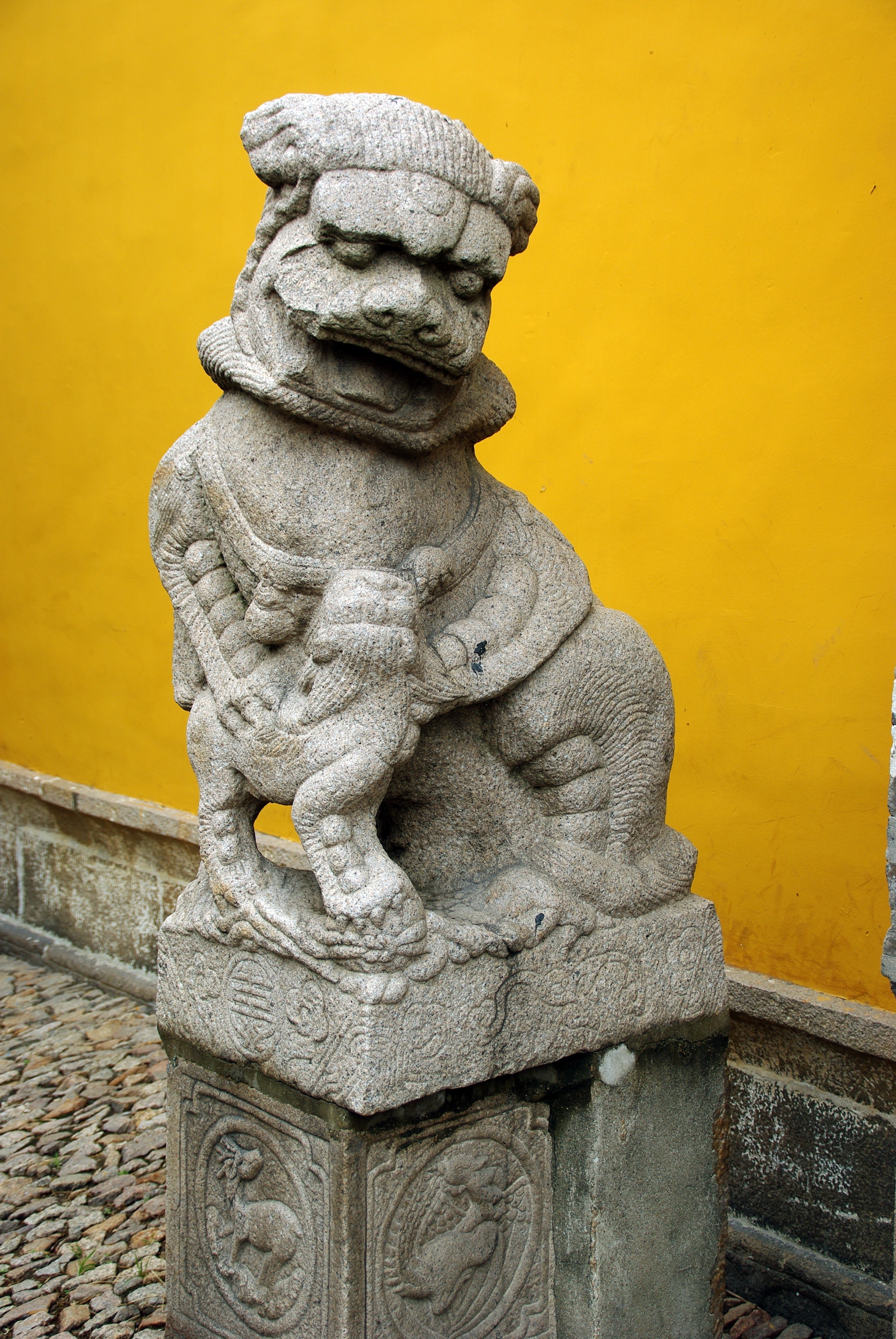 gray ceramic religious lion figurine