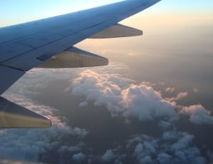 white clouds and blue sky and airplane wing thumbnail