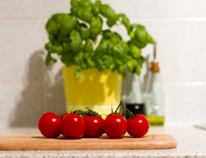 seven red tomato on brown wooden chopping thumbnail