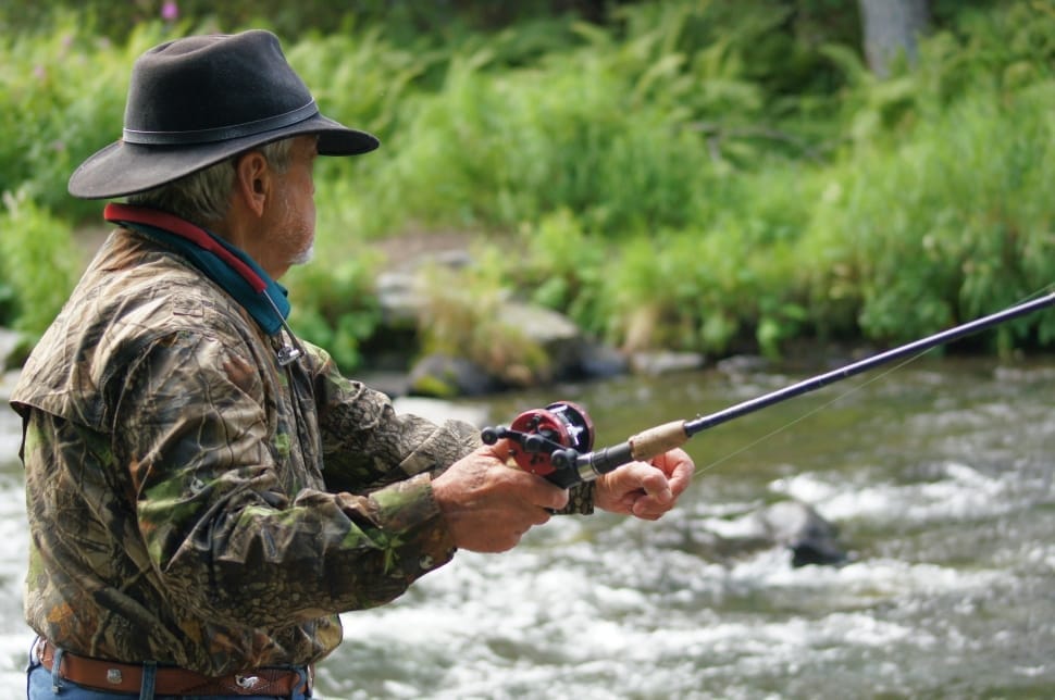 men's black hat green brown jacket and black fishing rod free