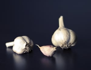 white garlic on blue surface thumbnail