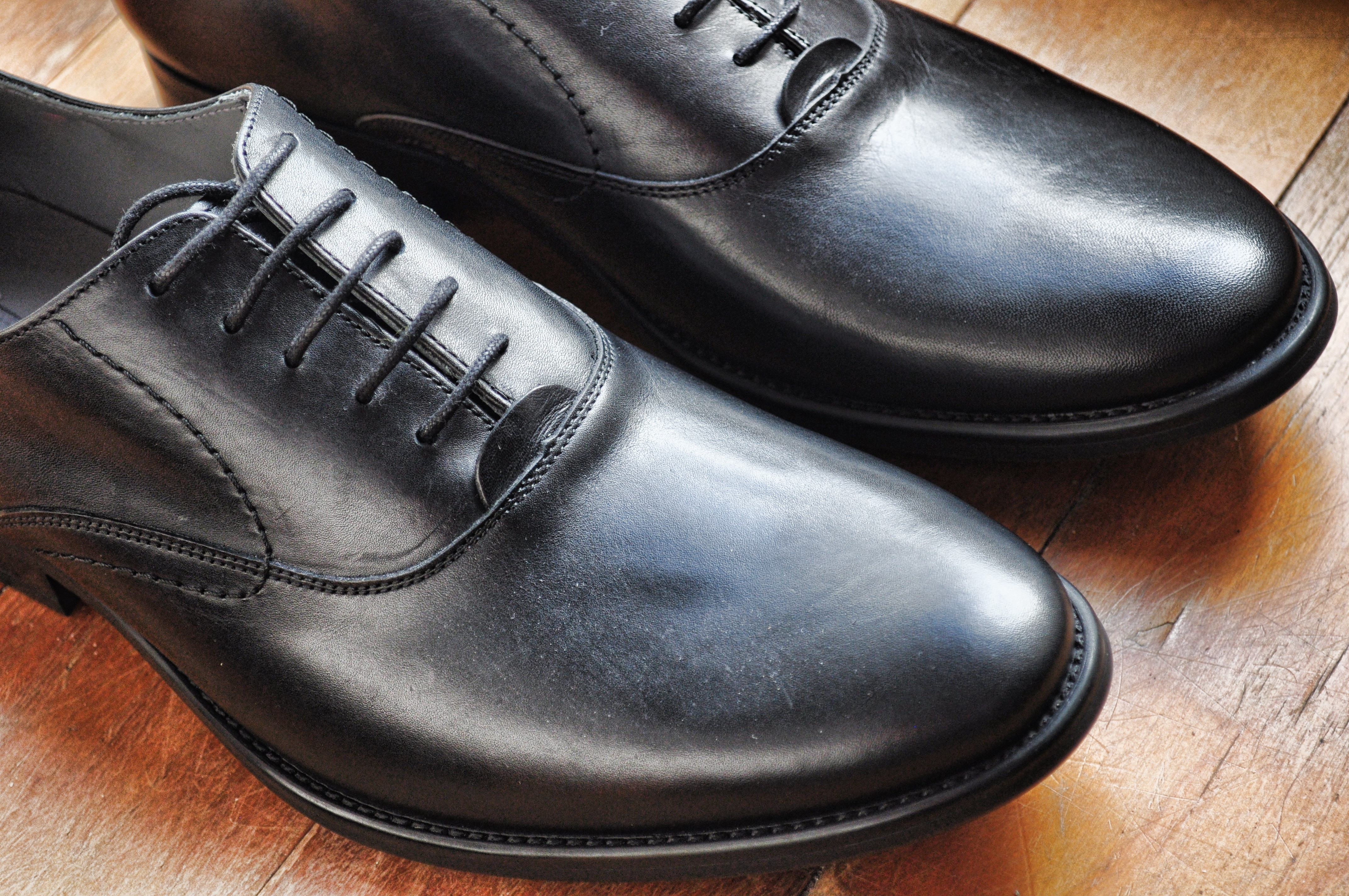 pair of black leather dress shoes