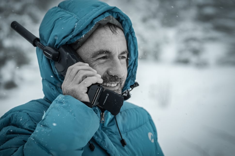 man holding telephone wearing bubble jacket preview