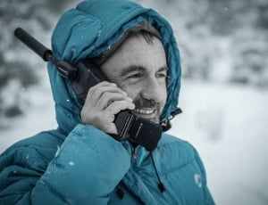 man holding telephone wearing bubble jacket thumbnail