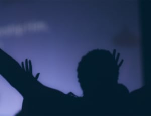 silhouette of human raising hand photo thumbnail