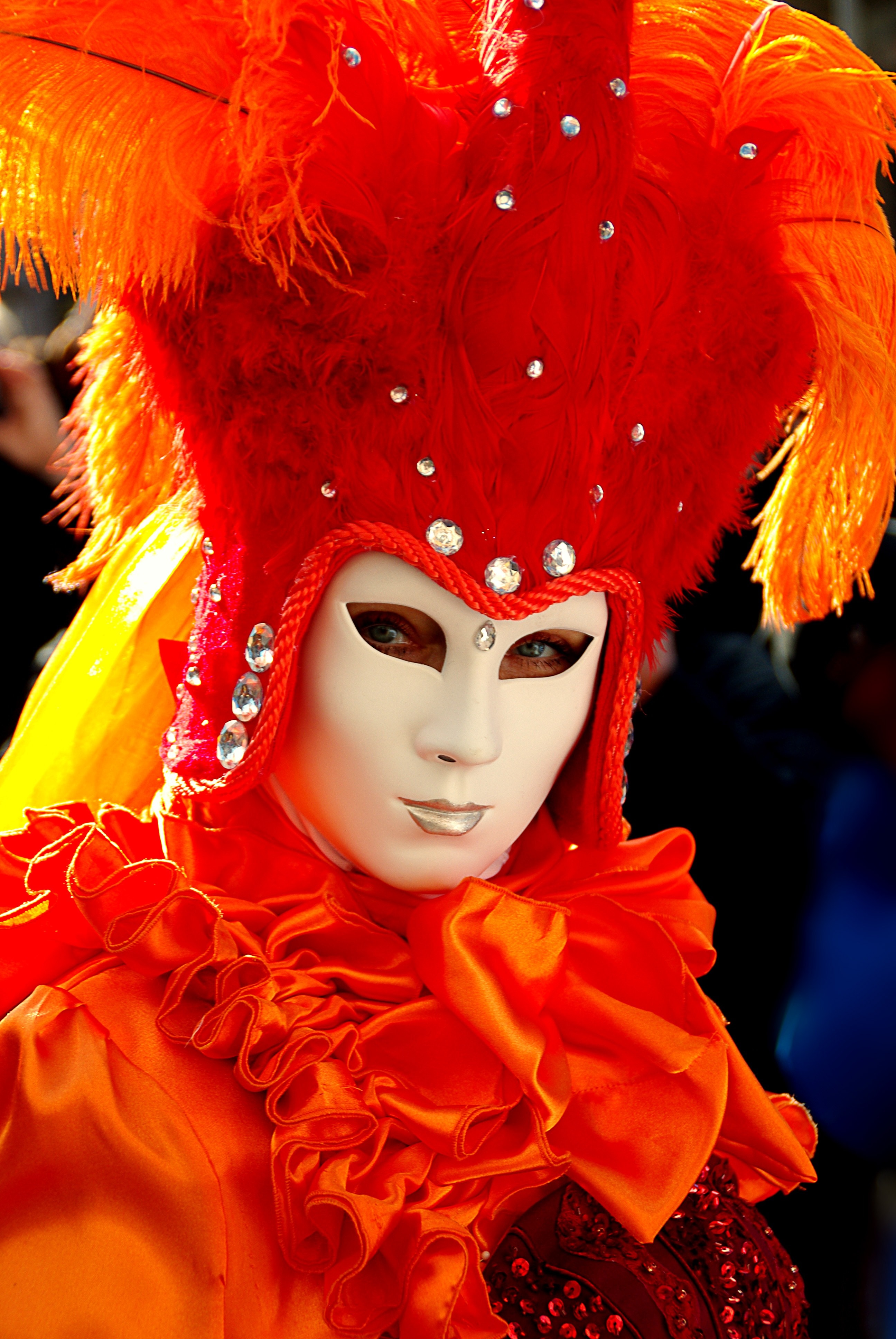 white and orange feathered mask