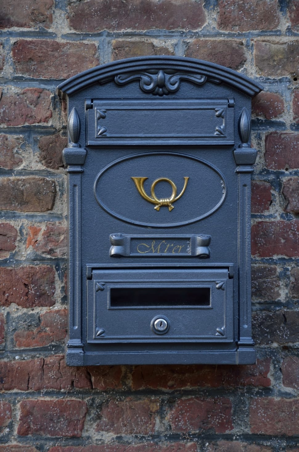 gray mail box mounted on brown bricked wall preview
