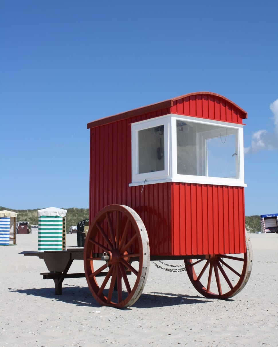 red and white wooden trailer preview