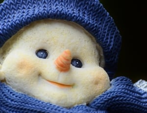 white snowman ceramic figurine in blue crochet costume thumbnail