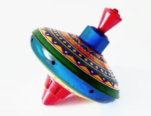 blue, green and red plastic spin top thumbnail
