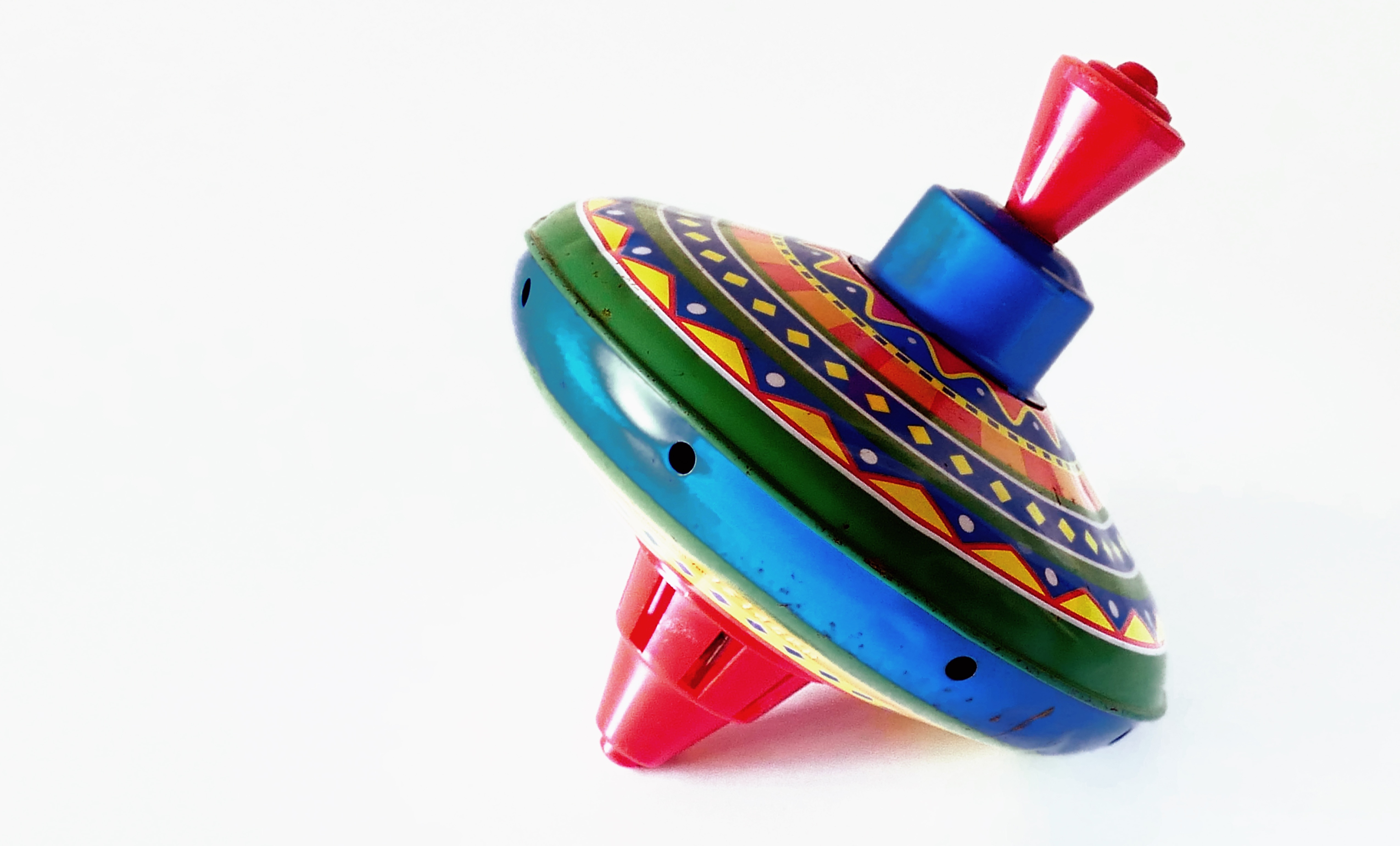 blue, green and red plastic spin top