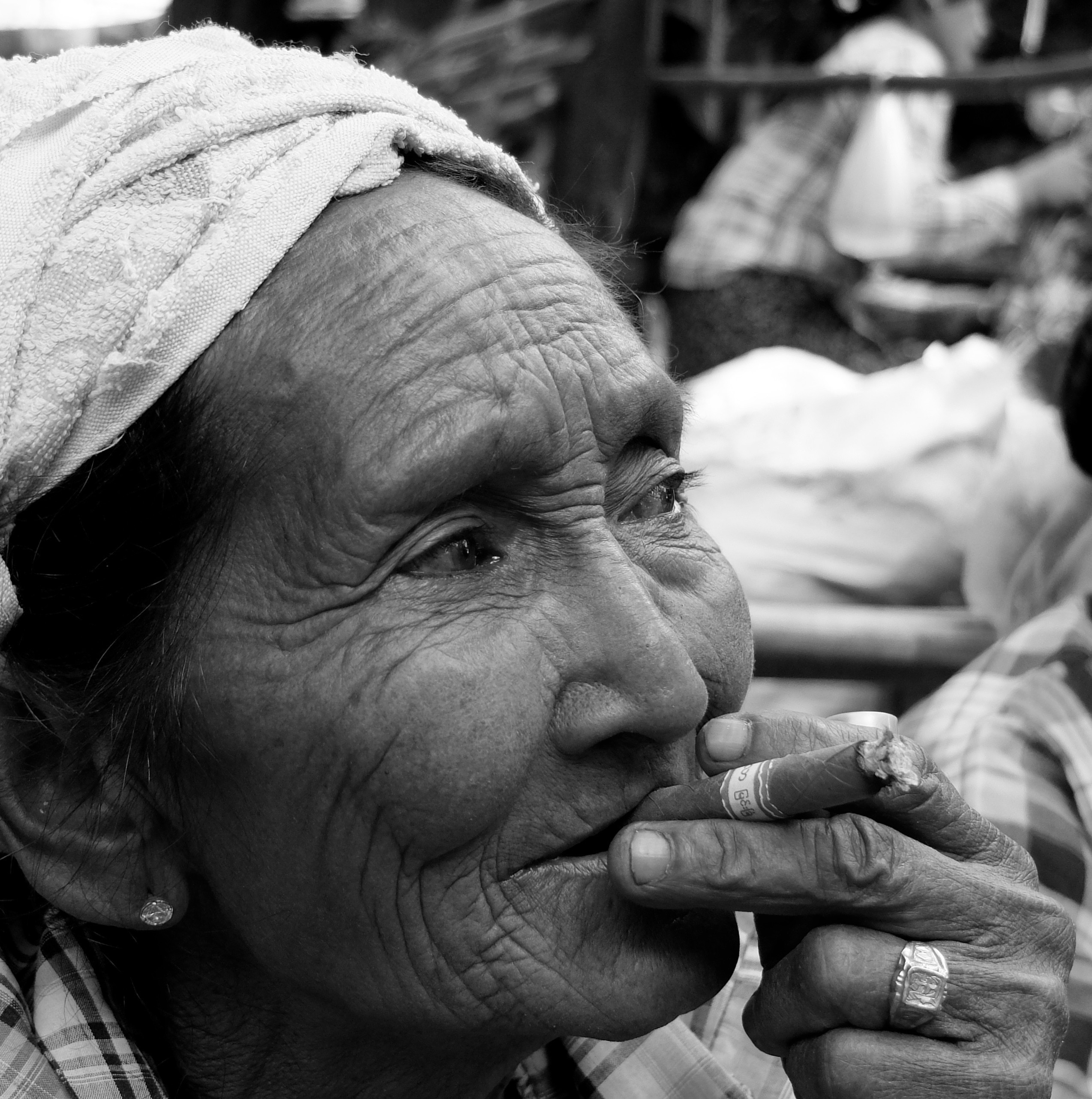 grayscale photography of woman puffing tobacco with signet ring