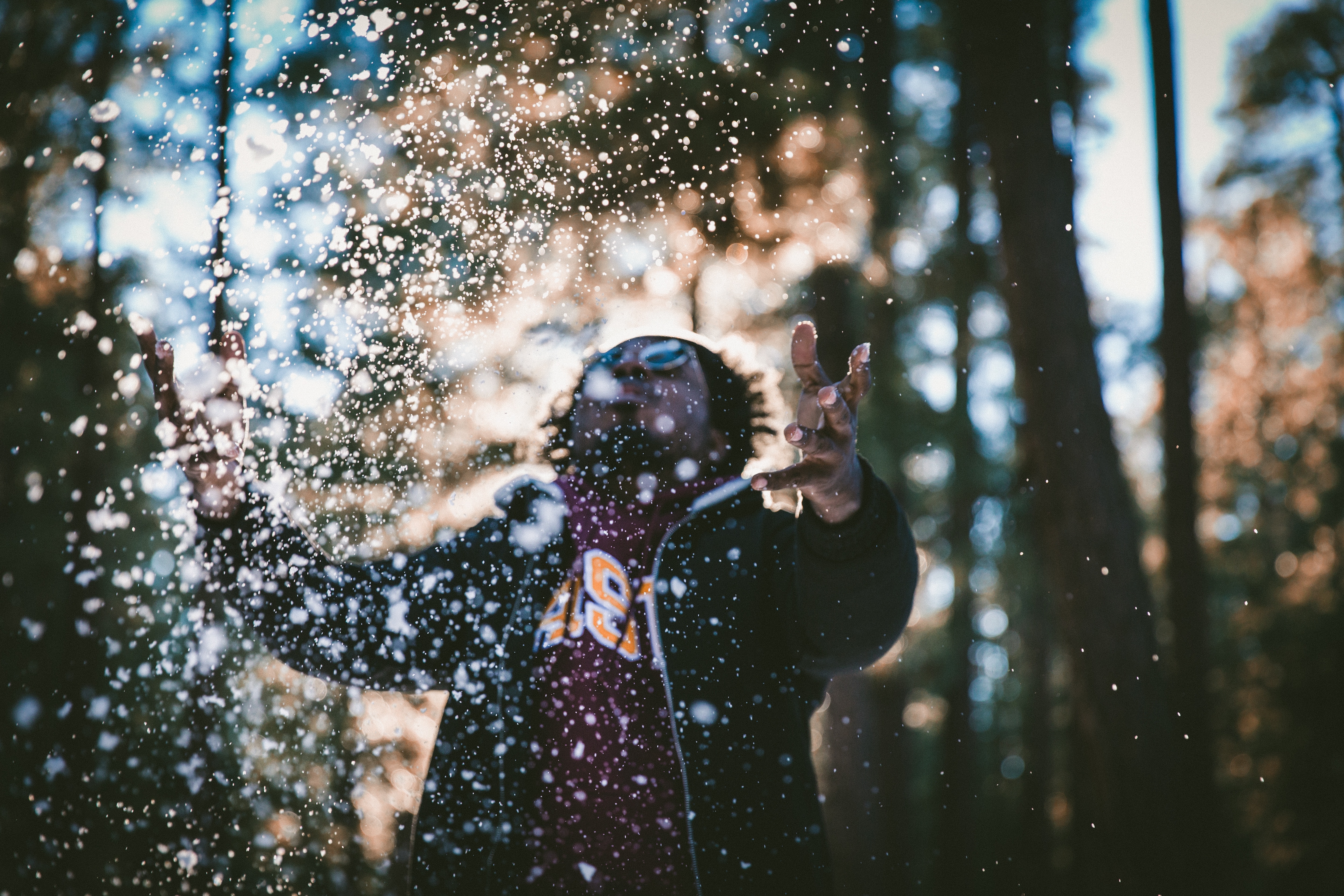 photograph of man in black jacket with water drops effects