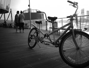 grayscale photo of tandem bicycle on dock thumbnail