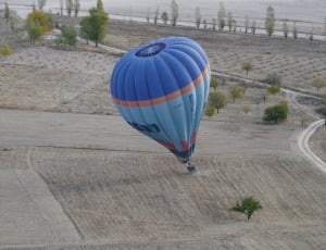 blue air balloon on gray open field during daytime thumbnail
