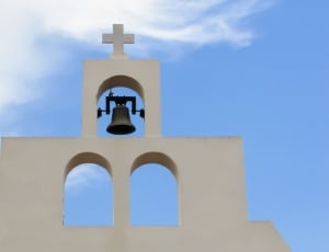 white concrete cathedral cross with bell thumbnail