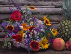 red blanket flowers, yellow sunflowers, red poppies, pine apple and apples thumbnail
