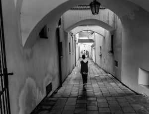 person walking the hallway grayscale photo thumbnail