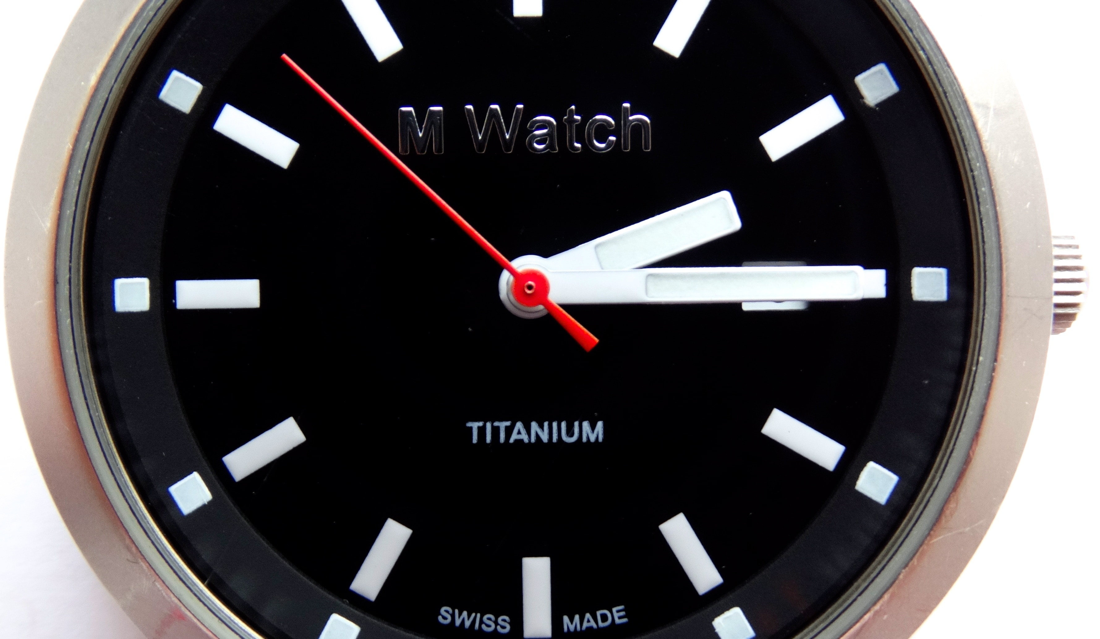 round silver M Watch analog watch