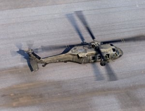 green fighter helicopter on gray concrete platform thumbnail