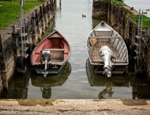 two gray-and-red wooden speedboat at daytime thumbnail