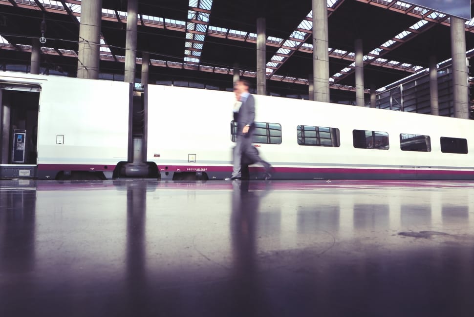 person in suit walking near train cabins preview