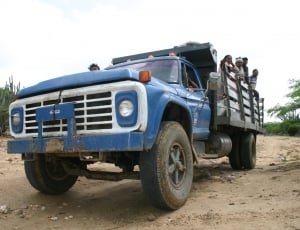 group of people riding blue truck thumbnail