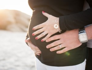 woman in black jacket and silver bracelet and white denim bottom during daytime thumbnail