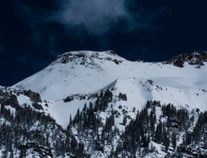 snow capped mountain under grey sky thumbnail