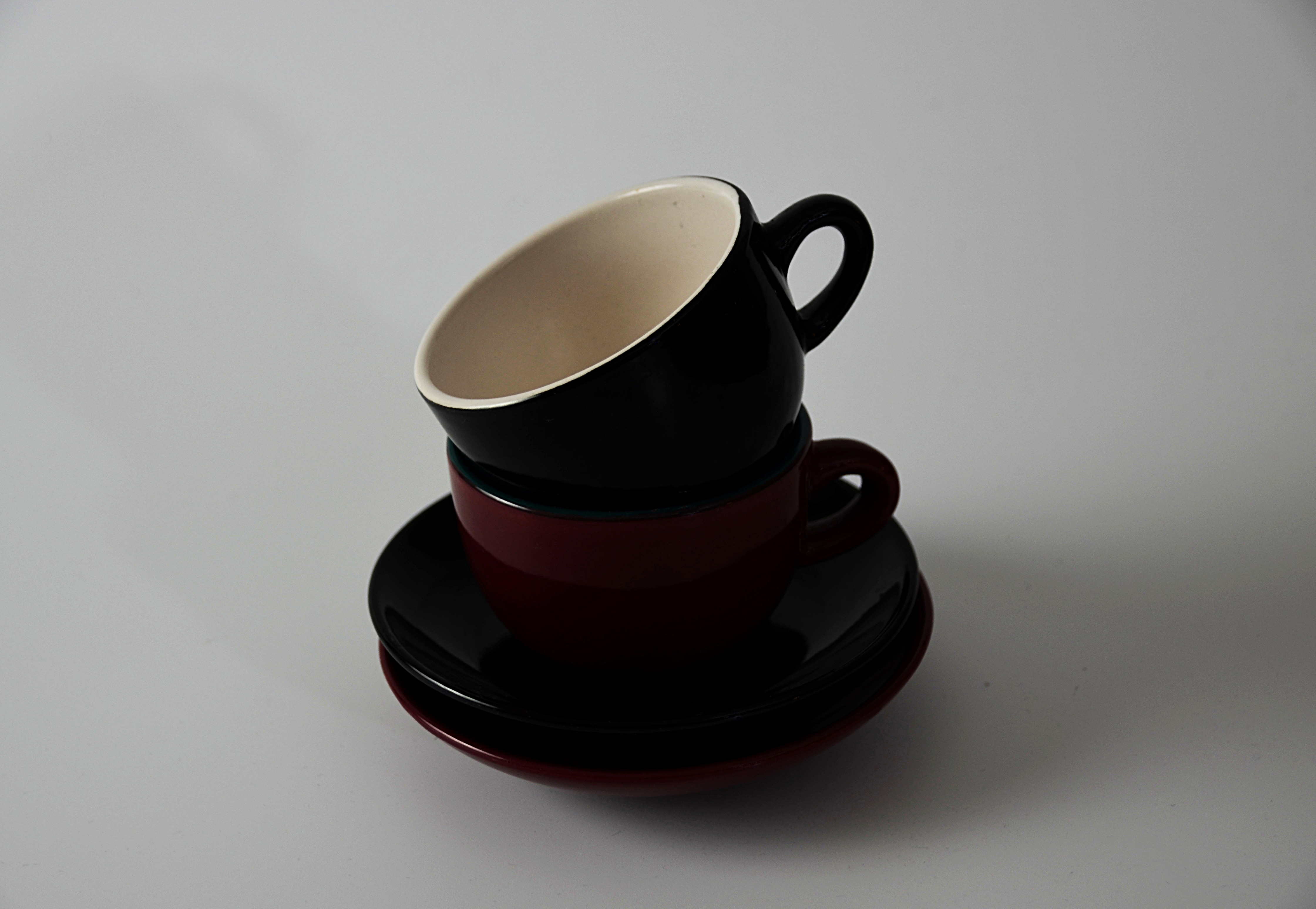2 brown ceramic cups with saucers