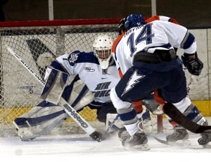captured image of ice hockey players near the net thumbnail