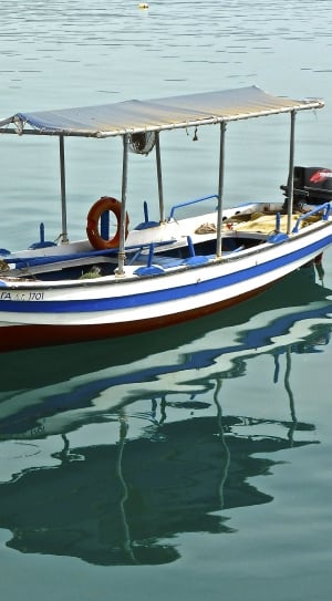 white blue and red boat with outboard motor thumbnail